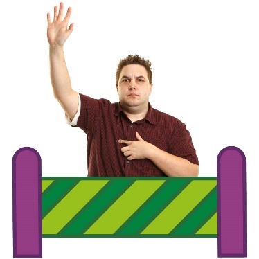 A person with their hand raised behind a barrier.