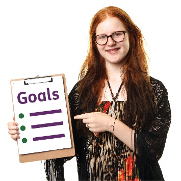A young person pointing at a list of goals.