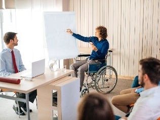 A person in a wheelchair giving a talk.