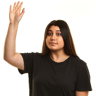 A woman raising her hand to say something.