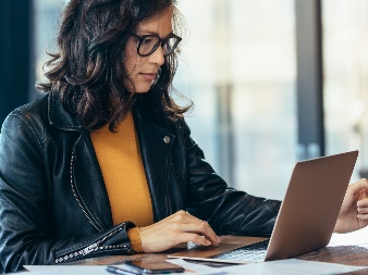 A woman using a laptop.