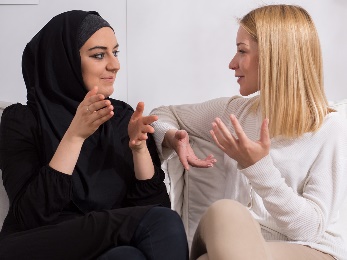 Two women talking to each other in the same language. 