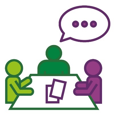 3 people around a table with a speech bubble. There are papers on the table. 