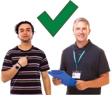 A worker next to a participant who is pointing at themselves. Above them is a tick.