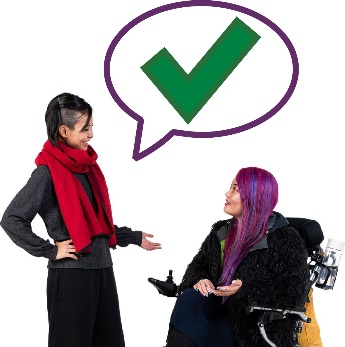 A participant and a worker having a conversation. Above the worker is a tick in a speech bubble.