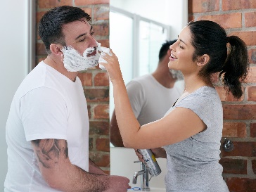 A worker supporting a participant to shave.