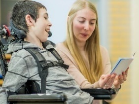 An NDIS worker showing a participant a document.