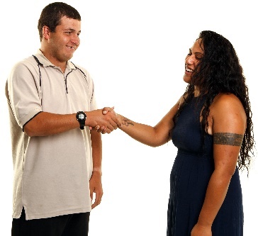 A participant and a support worker shaking hands.