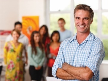 A team leader in front of a group of support workers.