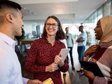 3 NDIS workers having a conversation in an office.