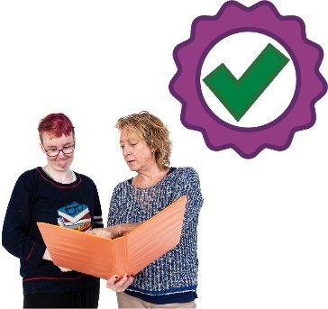 A participant and someone else looking at a document together. Next to them is a good quality icon.