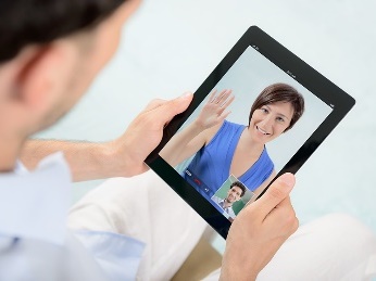 A participant using an iPad. They are having a video call with a worker.