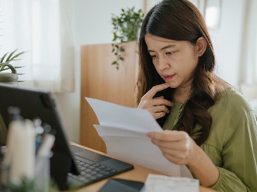 A participant looking at 2 documents and thinking.