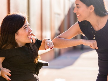 A participant and a worker smiling together.