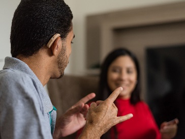 A participant and a worker having a conversation using Auslan.