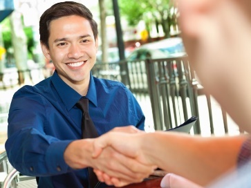 A worker and someone else shaking hands.