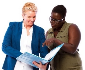 2 people looking at a document together.