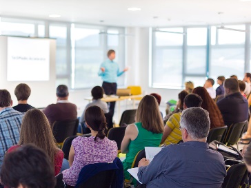 A person giving a presentation to a large group of people.