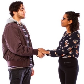 A participant and a worker shaking hands.