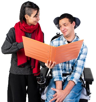 2 people looking at a document. One of them is in a wheelchair.