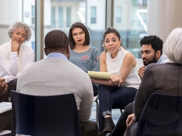 A group of people having a meeting in an office.