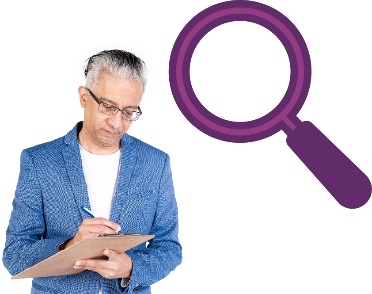 A person writing on a document and a magnifying glass.