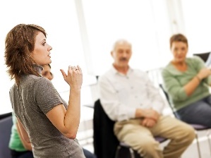 A person presenting to a group of people.