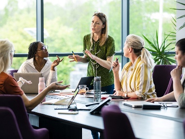 A group of people working together in a meeting.