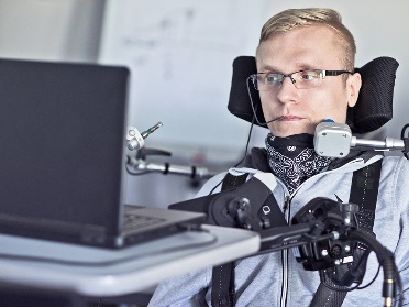 A person using assistive technology with a laptop.