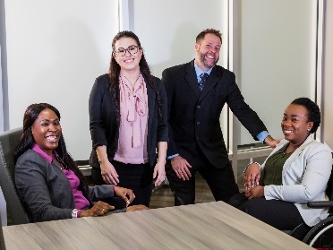 A group of smiling people in an office.