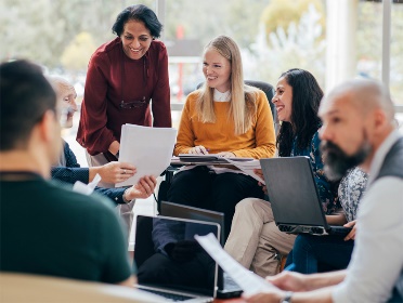 A group of people looking at documents.