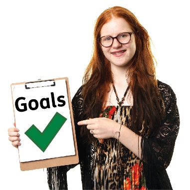 A person holding a document called "Goals" with a tick on it.