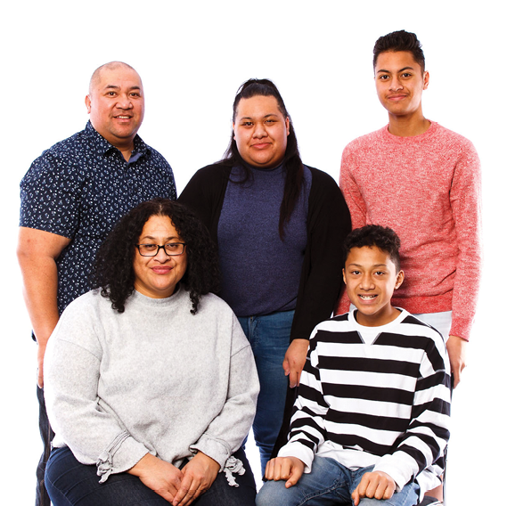 A family of 5 smiling.