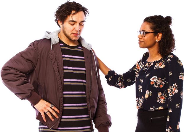 A person with their hand on another person's shoulder.