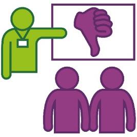 A person presenting at a training session. They are pointing to a thumbs down.
