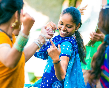 2 people dancing in traditional clothes.