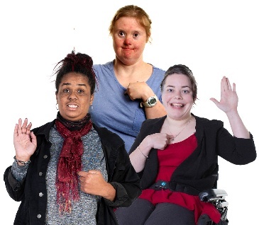 3 women with disability pointing to themselves.