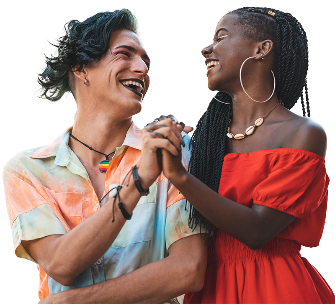 2 people smiling and holding hands. 1 of them is wearing a pride necklace.