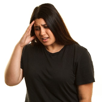 A person with a hand on their head looking upset.