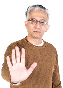 A person holding their hand out to say stop.